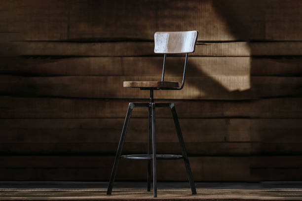 istock Tall bar stool on a wooden background 1438076294