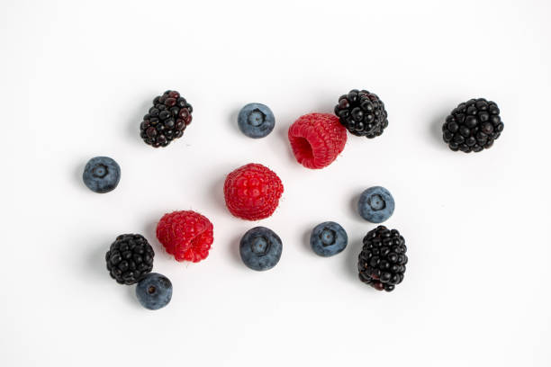 istock Blackberries, raspberries and blueberries isolated on a white background 1438076829
