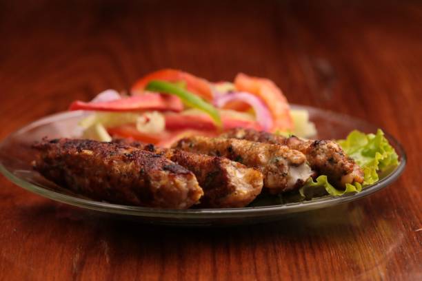 istock Fried meat with lettuce and tomato on the plate 1438078553