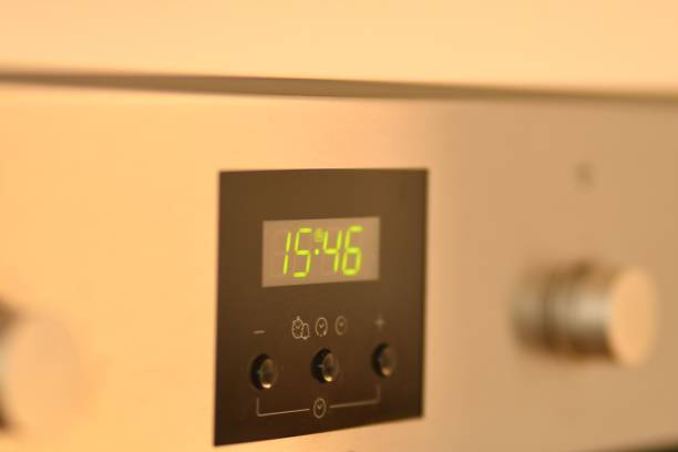 istock Green LED digital clock on an oven in Germany 1438078573