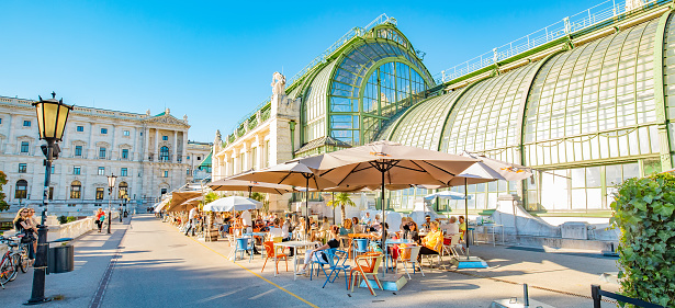 Vienna, Austria - 23 May, 2022: Summer street cafe in Wien old town, Butterfly House (Schmetterlinghaus) on background