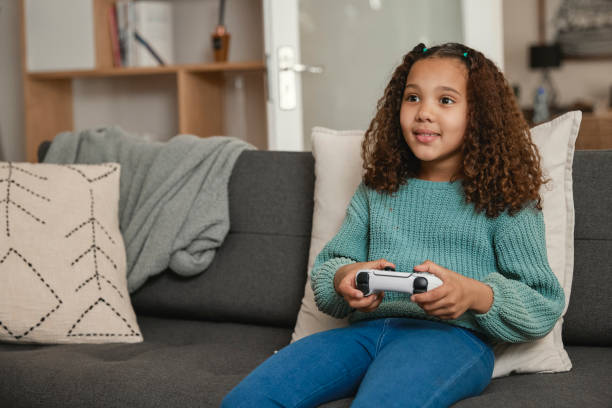 istock Young girl playing video games 1438079084