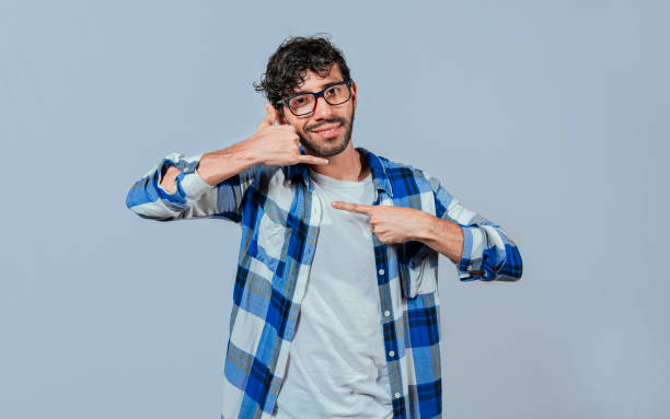 istock Interpreter man gesturing CALL ME in sign language. Person gesturing CALL ME in sign language, Young man gesturing CALL ME in sign language. Manual gestures of people with hearing problems 1438079111
