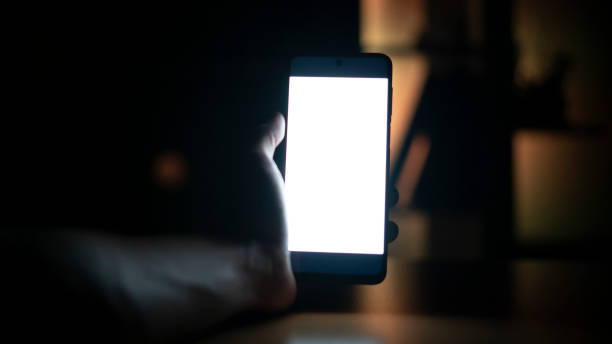 istock Man holding phone in the dark at night , Mock Up screen 1438079584