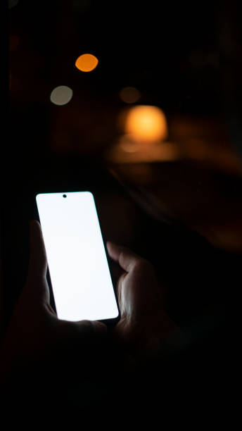 istock Close-up Man holding phone by the window 1438079814