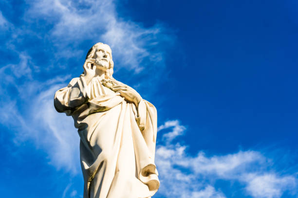 istock Low angle shot of Jesus sculpture against a blue sky background 1438081707