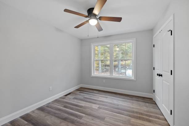istock White empty room with wooden doors and broad windows in a newly constructed house 1438081801