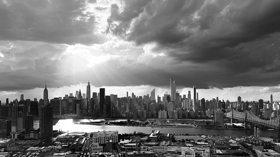 NEW YORK, United States – October 25, 2022: A dark aerial shot of the Manhattan skyline from Queens Court Square with backlighting