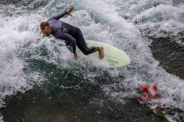 Photo of a couple in wetsuits on the river