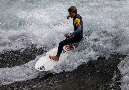 Thun, Switzerland – August 24, 2021: A surfer on the Aare river in Thun, Switzerland