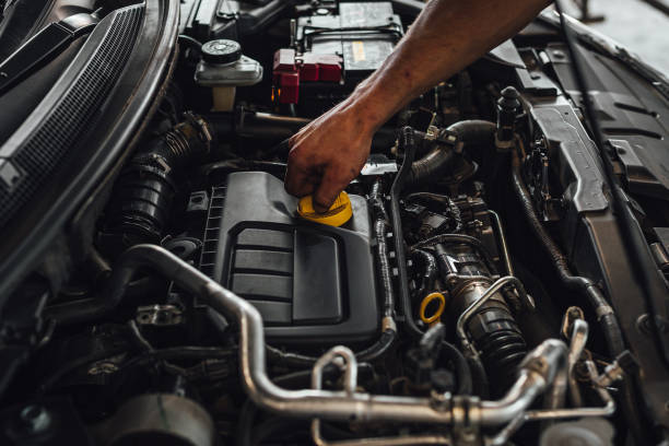 istock Auto mechanic working on a car engine, technical car inspection in service 1438082718
