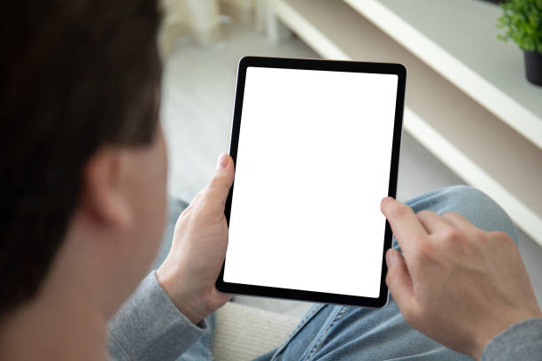 male hands hold computer tablet with isolated screen background room stock photo