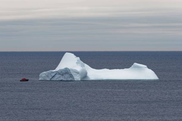 istock Coastal iceberg with tour boat 1438082768