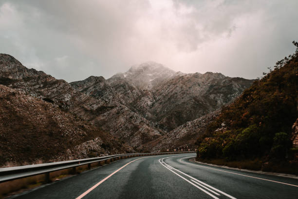 istock Asphalt road surrounded by high mountains - great for wallpapers 1438083298