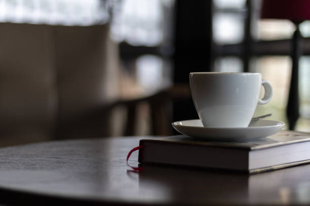 istock Selective focus shot of a cup of cappuccino with a plate on a cafe table 1438084248