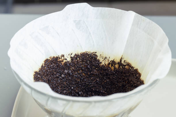 istock Closeup shot of ground wet coffee in a filter 1438084736