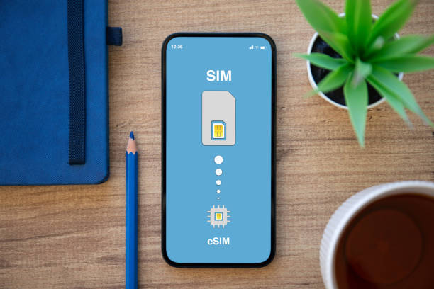 phone with Sim card replacement on eSim on screen stock photo