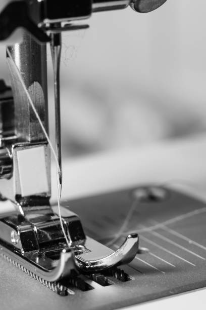 istock Vertical grayscale macro shot of a sewing machine presser foot 1438085271