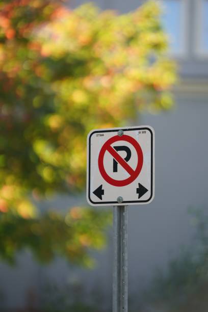 istock Vertical shot of a no parking sign isolated on a blurred background 1438085285