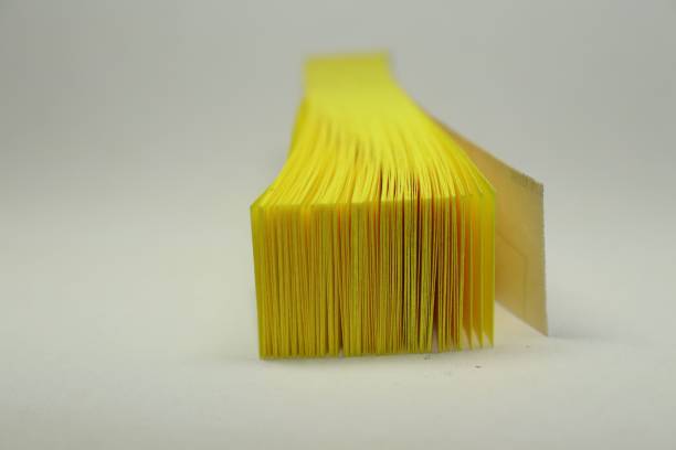 istock Closeup of yellow sticky notes isolated on a white background 1438086454