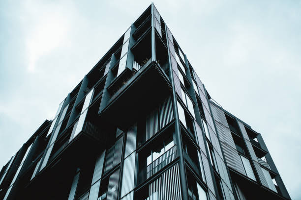 istock Low angle shot of a modern building with glass windows 1438086923