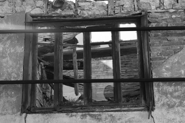istock Broken windows of the ruined house 1438088027