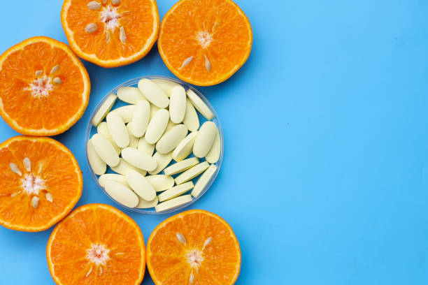 istock Vitamin C pills with  fresh orange citrus fruit 1438091634