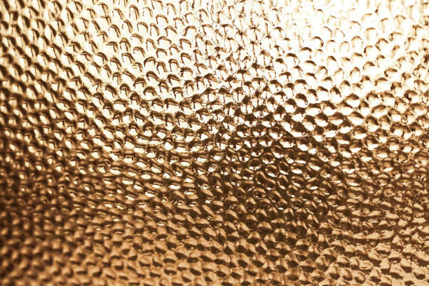 Shining golden color textured glass background