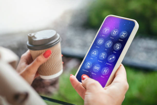 istock a woman holds a mobile phone with an astrological application 1438096681