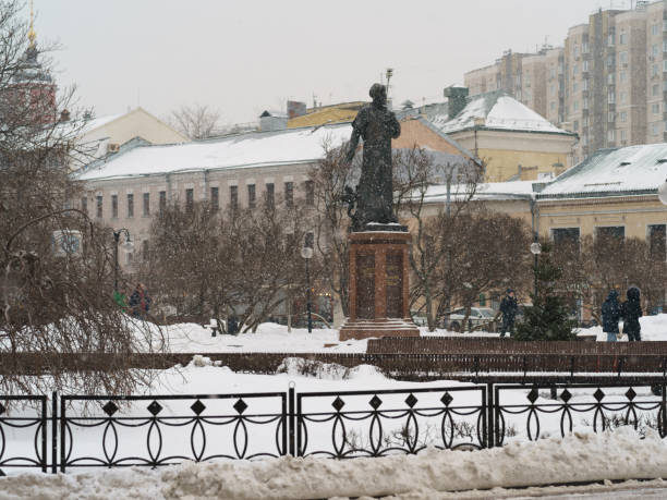 Moscow, Russia - November 3, 2021: Cityscape in winter day. Snowfall. The statue to Ali-Shir Nava'i is located on the Serpukhovskaya square. Heritage concept.