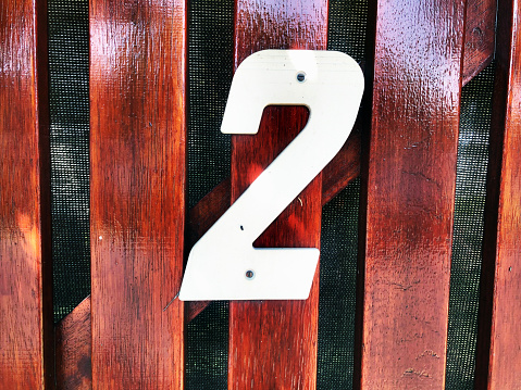 Number 2 sign on a wood gate