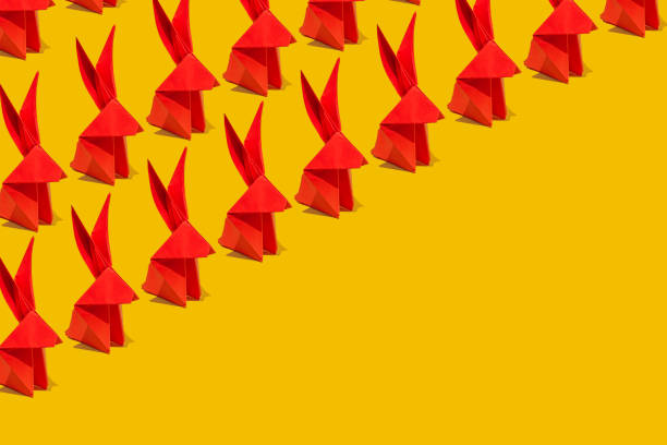 Paper origami Esater rabbit on yellow background. Easter celebration concept