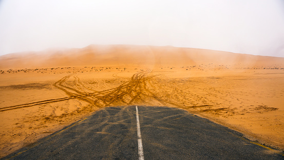 highway abruptly terminated ending in the desert in front of the dunes in namibia