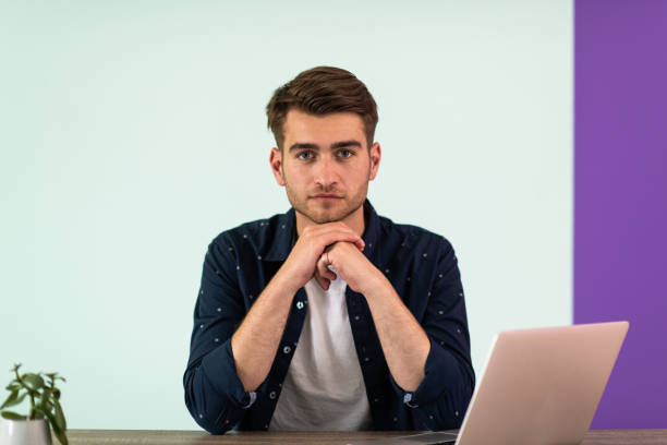 Smiling young man freelancer using laptop studying online working from home.