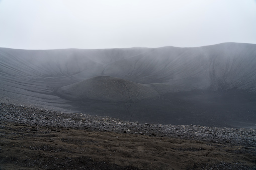 High angle view of huge Hverfjall volcanic crater on cloudy day.  Hverfjall, is one of the best preserved circular volcanic craters in the world and it is possible to walk around and inside it.