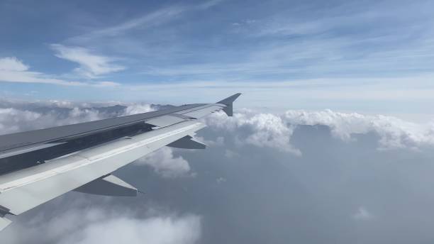 istock Paro, Bhutan - February 3, 2022: Airplane descends above the clouds 1438103331