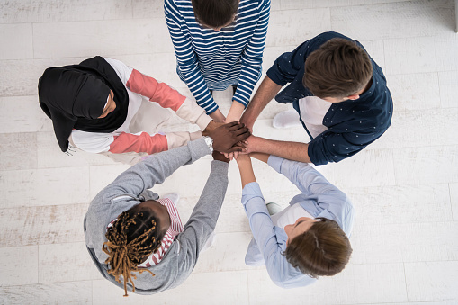 Top view of a diverse group of people symbolizes togetherness. High quality photo