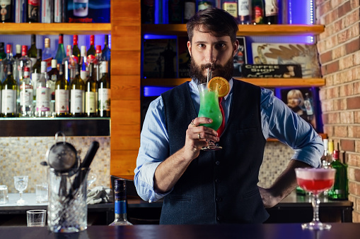 Bartender tastes the new cocktail