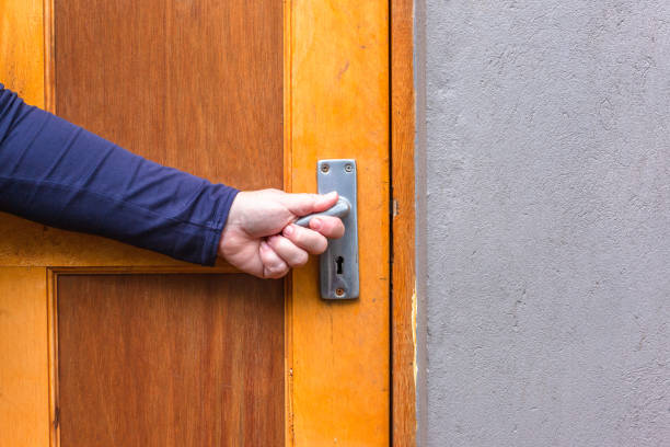 istock Door Handle Human Hand Closeup Outdoors 1438108692