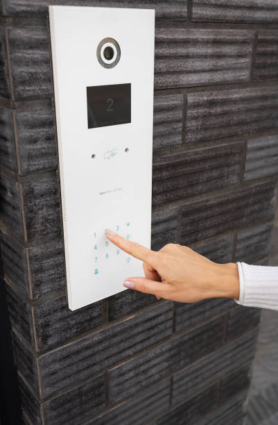 door access control - a young woman enters a code to open the door. code door, home protection. - biometrics control panel touching fingerprint imagens e fotografias de stock