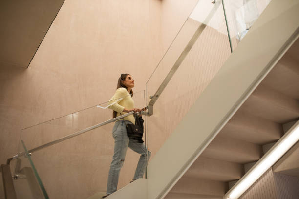 istock Young woman going upstairs 1438110661