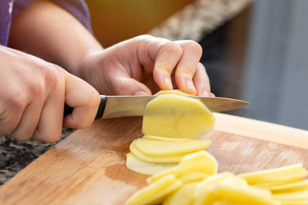 istock woman chopping potatoes 1438111013