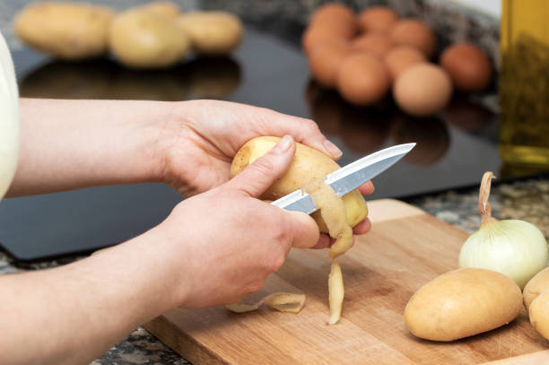 istock peeling potatoes on the wooden 1438111039