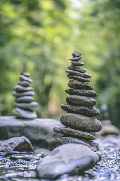 istock Vertical shot of two stone pyramids balanced on a river water 1438112405