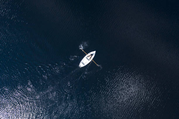 istock Boat on lake from the sky 1438112619