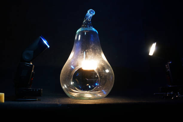 Silhouette led lamps against the background of the silhouette of the layout of the house on a yellow background.
