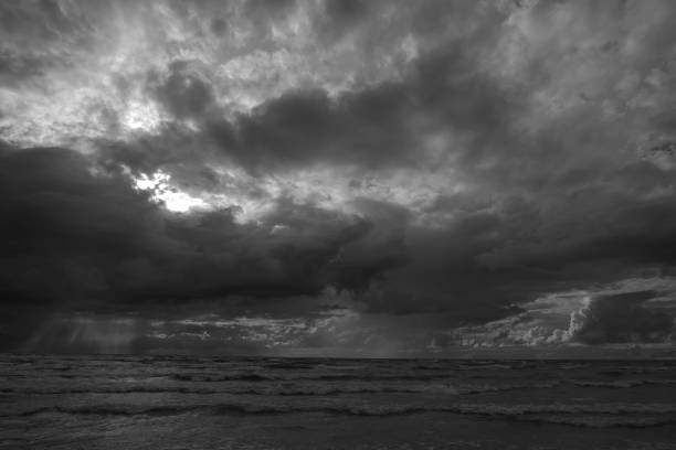 istock Grayscale shot of seascape against dramatic sky with clouds 1438113558