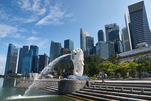 Singapore, Singapore – August 19, 2020: Iconic merlion landmark at marina bay in Singapore against the central business district city skyline. Little visitors due to travel restrictions