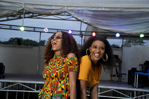 A closeup shot of two black girls dancing cheerfully