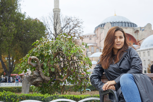 young tourist sitting on bench in historic istanbul location